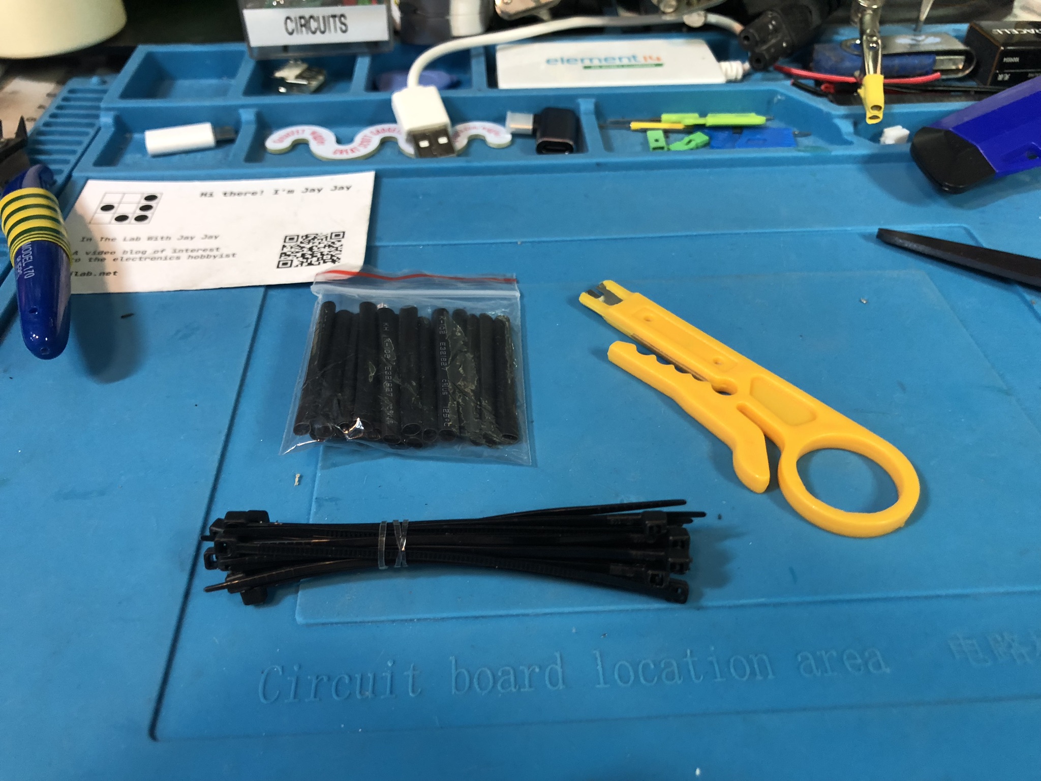 A photo of the zip ties, heat shrink, and wire stripper on John's bench